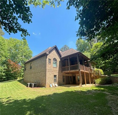Rear view of house featuring a patio, a yard, ceil