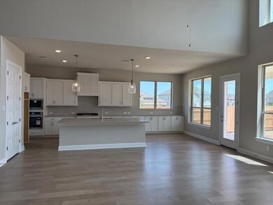 Kitchen with black oven, backsplash, white cabine