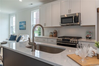 Kitchen with light stone counters, appliances with