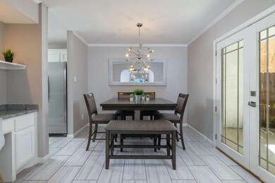 Dining space with a chandelier and crown molding -