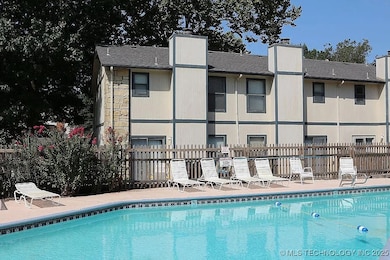 Community pool featuring fence and a patio area