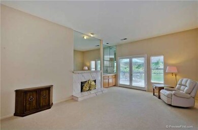 Spacious living room with fireplace and wet bar.