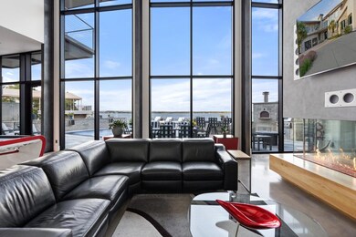 Living area with a water view, a towering ceiling