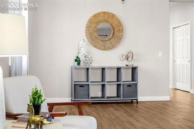 Sitting room featuring baseboards and finished flo