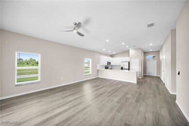 Unfurnished living room with ceiling fan, a wealth