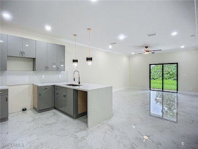 Kitchen featuring gray cabinets, light marble fini
