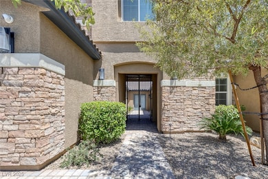 Property entrance with stone siding, stucco siding