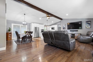 LR has hardwood floors, vaulted ceiling w/ beam for character, and updated lighting