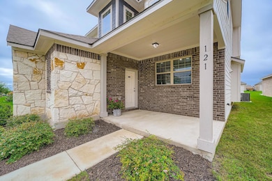 Doorway to property with stone siding, a yard, an
