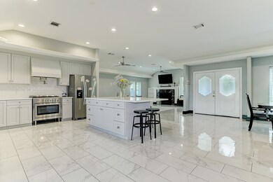 Entry way opens to the spacious kitchen. Bright porcelain floors offer a clean and fresh look throughout the home.