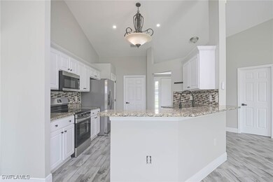 Kitchen with decorative light fixtures, stainless