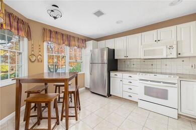 Eat-in-kitchen with new cabinetry, appliances, cou