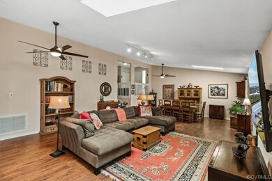Living Room boasts HW floors, vaulted ceilings and