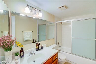 Bathroom with toilet, shower / bath combination wi