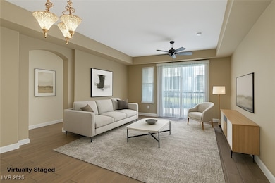 Virtually staged showing arched walkway, tile floo