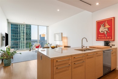 Kitchen with expansive windows, light stone counters, recessed lighting, dark wood finished floors, and open floor plan