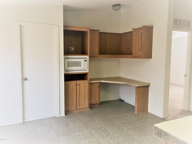Kitchen microwave and desk area