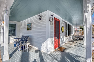 APPEALING TWO SIDED PORCH WITH ENTRANCES INTO FRONT FOYER OR INTO THE LIVING/DINING ROOMS