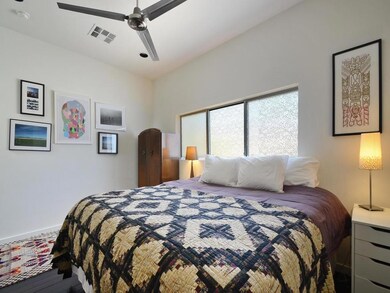 Bedroom with ceiling fan and wood finished floors