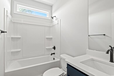 Full bathroom featuring vanity, toilet, and bathtu