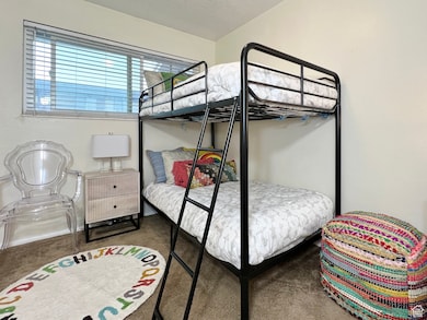 Carpeted bedroom featuring a textured ceiling