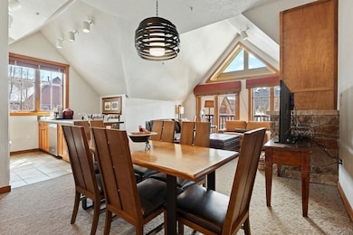 Carpeted dining area featuring a textured ceiling