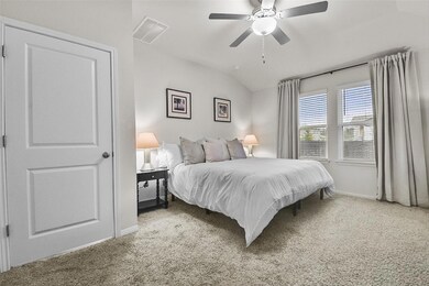Bedroom featuring baseboards, carpet flooring, lo