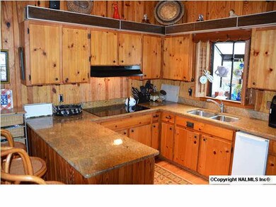 Open kitchen with granite countertops and an amazing view of the river. The kitchen offers a smooth cooktop, dishwasher and trash compactor.