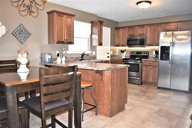 Eat in kitchen with breakfast bar. Stainless steal appliances and tile floors. 