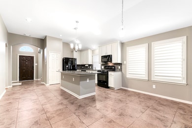 Continuing past the front door, you’ll be greeted by the spacious island kitchen, complete with barstool seating, perfect for casual dining or entertaining. Adjacent to the kitchen is a large dining room, creating a seamless flow for gatherings and family meals.