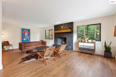 Large open living with new flooring, wood burning 