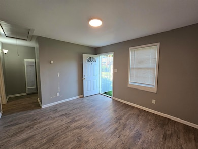 Empty room with attic access, a heating unit, dark