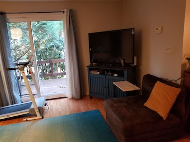 Living room with slider and view of deck