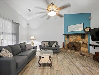 Living room with ceiling fan, lofted ceiling, and 