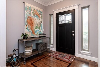 Welcome entry way with solid hardwood floors, crown moulding, and wonderful trim details.
