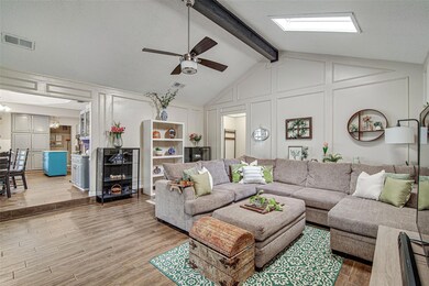 Living area with visible vents, vaulted ceiling wi