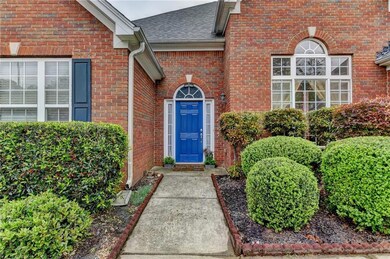 Doorway to property featuring brick siding and a s