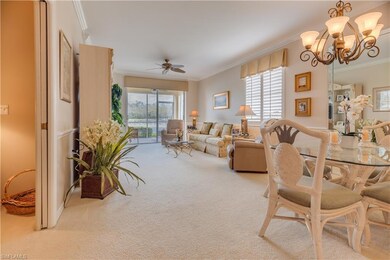 Carpeted living room featuring ceiling fan with no