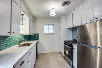 Kitchen with stainless steel appliances, sink, bac