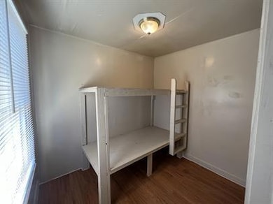 Unfurnished bedroom featuring wood finished floor