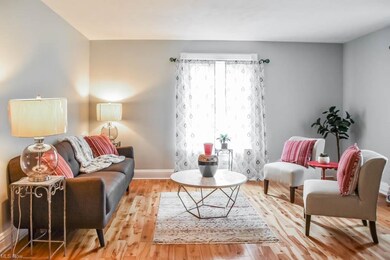 Sun-filled living room with hardwood floors.
