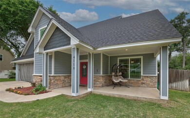 View of front of house featuring fence, roof with