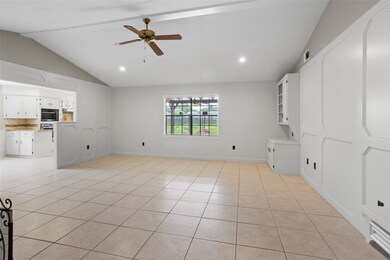 This spacious living area features neutral tile fl