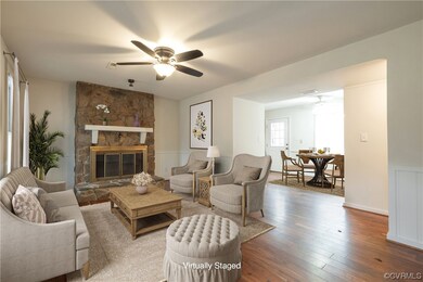 Living room with light wood-type flooring, a firep