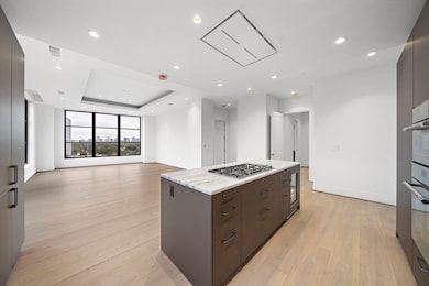 Kitchen features ample storage, gas cooktop & and