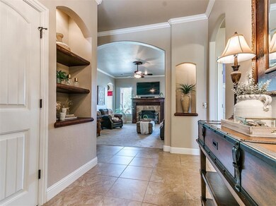 Hall featuring crown molding, built in shelves, an