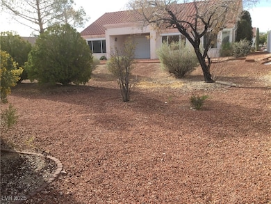View of front of house with stucco siding and a ti