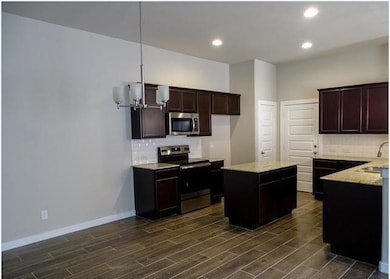 Kitchen featuring stainless steel appliances, bac