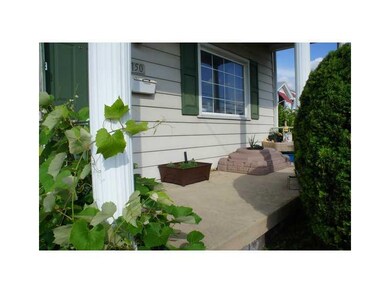 Exterior Front. Front porch with mature grape vine