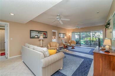 Large tiled living room with two ceiling fans